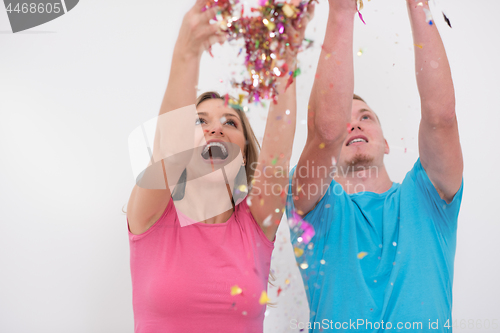 Image of romantic young  couple celebrating  party with confetti