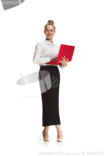 Image of Full length portrait of a smiling female teacher holding a laptop isolated against white background