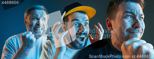 Image of The emotional angry men screaming on blue studio background