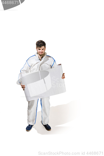 Image of Young male decorator painting with a poster climbed a ladder isolated on white background.