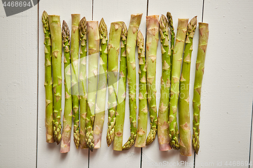 Image of Above view of flat-lay organic raw uncooked green asparagus