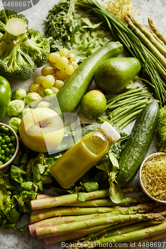 Image of Green antioxidant organic vegetables, fruits and herbs placed on gray stone