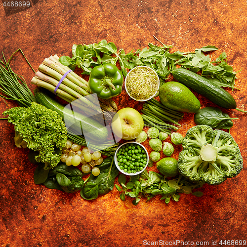 Image of Fresh green vegetables and fruits assortment placed on a rusty metal