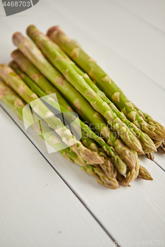 Image of Above view of flat-lay organic raw uncooked green asparagus