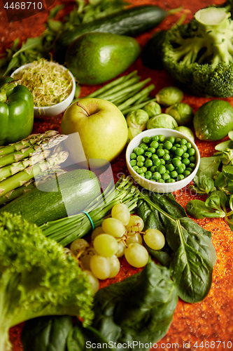 Image of Fresh green vegetables and fruits assortment placed on a rusty metal