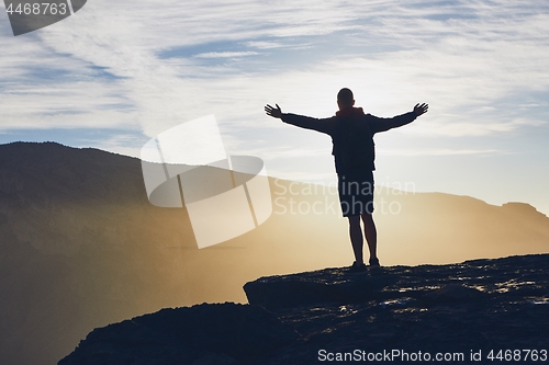 Image of Tourist on the edge of cliff