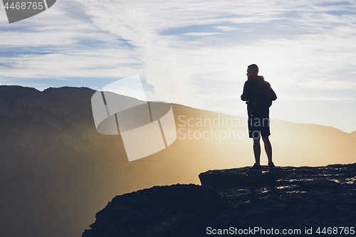 Image of Tourist on the edge of cliff