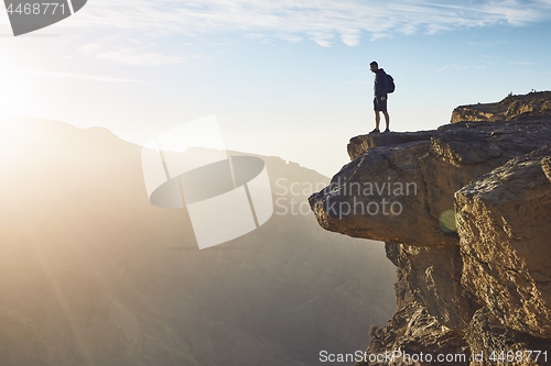 Image of Tourist on the edge of cliff