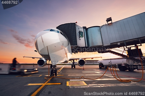 Image of Busy airport at the colorful sunset