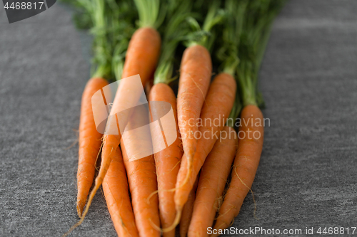 Image of close up of carrot bunch on table