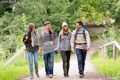 Image of friends or travelers with backpacks and tablet pc