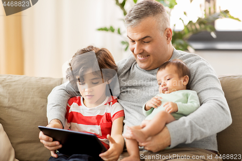 Image of happy father with preteen and baby son at home