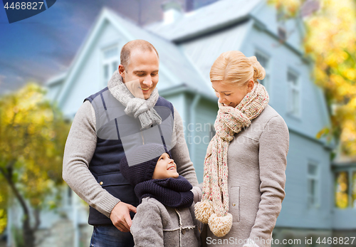 Image of happy family over living house in autumn