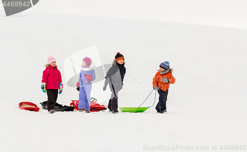 Image of happy little kids with sleds in winter