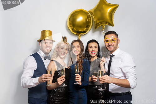 Image of happy friends with champagne glasses at party