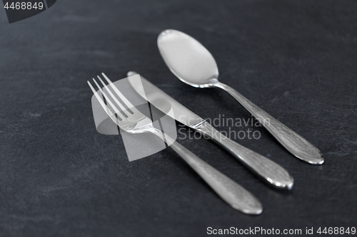 Image of close up of fork, knife and spoon on table