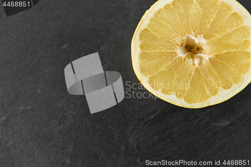 Image of close up of lemon slice on slate table top