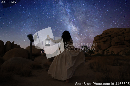 Image of Girl Holding Lantern in the Desert Under the Milky Way