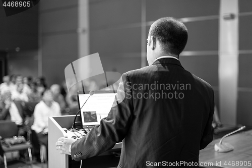 Image of Public speaker giving talk at Business Event.