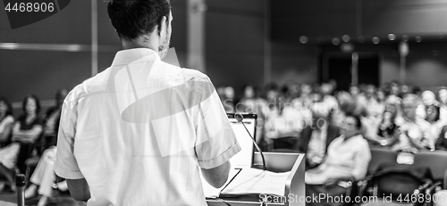 Image of Public speaker giving talk at Business Event.