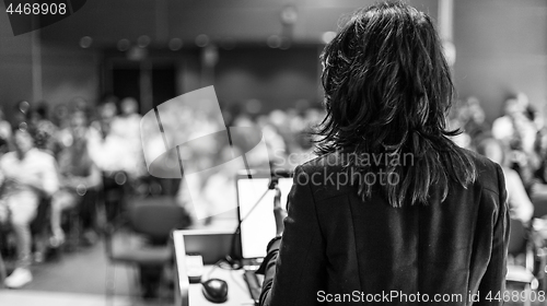 Image of Public speaker giving talk at Business Event.