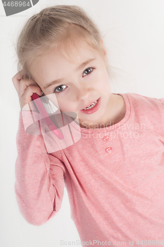 Image of Little girl talking on mobile 