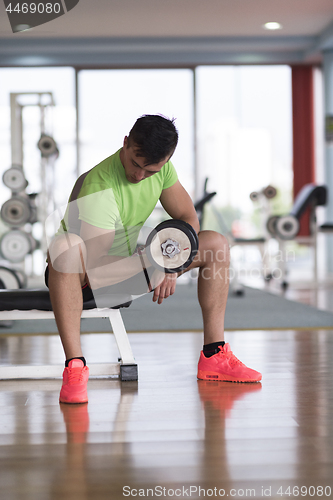 Image of handsome man working out with dumbbells