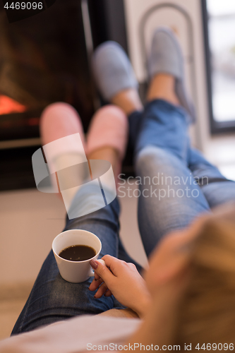 Image of Young couple  in front of fireplace