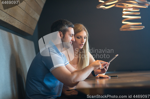 Image of couple using tablet at home