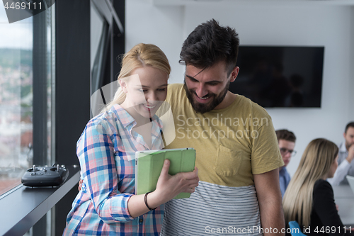 Image of Business People Working With Tablet in startup office