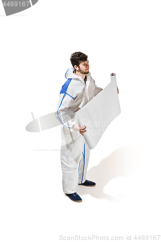 Image of Young male decorator painting with a poster climbed a ladder isolated on white background.