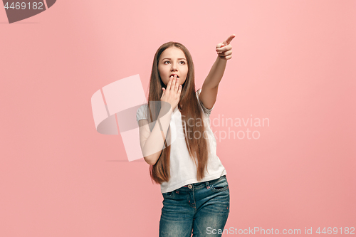 Image of Beautiful teen girl looking suprised isolated on pink