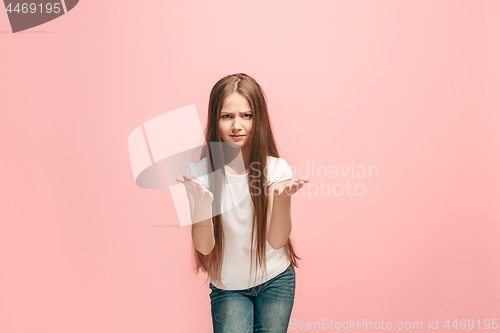 Image of Beautiful female half-length portrait on pink studio backgroud. The young emotional teen girl