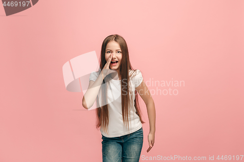 Image of young casual teen girl shouting at studio