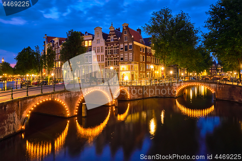 Image of Amterdam canal, bridge and medieval houses in the evening