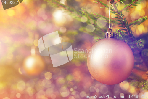 Image of Christmas-tree decoration bauble on decorated Christmas tree bac