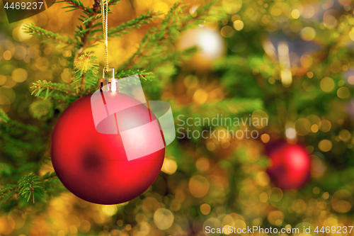 Image of Christmas-tree decoration bauble on decorated Christmas tree bac