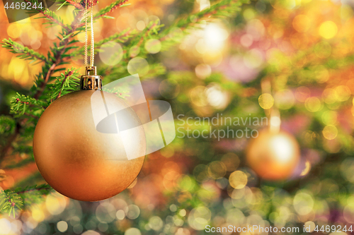 Image of Christmas-tree decoration bauble on decorated Christmas tree bac