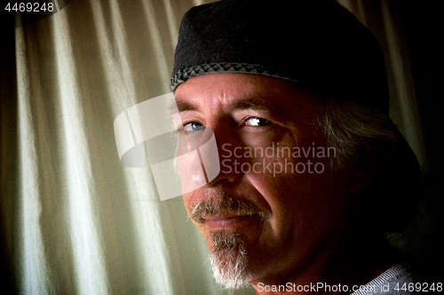 Image of smiling man with hat and goatee