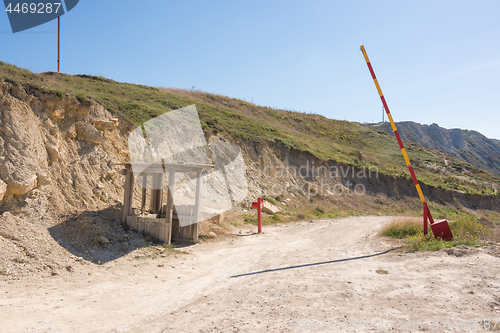 Image of Mountain road, abandoned barrier and security booth