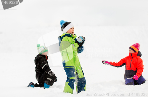 Image of happy little kids playing outdoors in winter