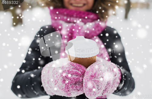 Image of close up of hand with coffee outdoors in winter