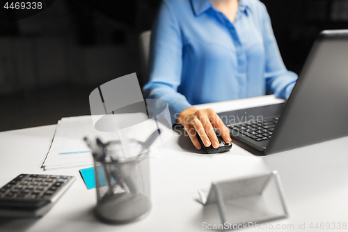 Image of close up of businesswoman using computer mouse