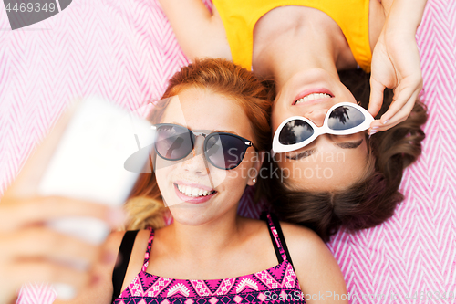 Image of teenage girls in sunglasses taking selfie