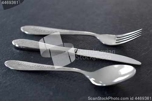 Image of close up of fork, knife and spoon on table