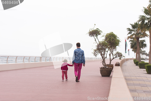 Image of mother and cute little girl on the promenade by the sea