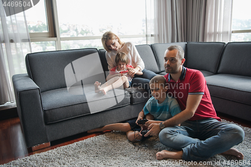 Image of Happy family playing a video game