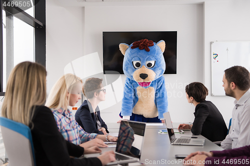 Image of boss dresed as bear having fun with business people in trendy of