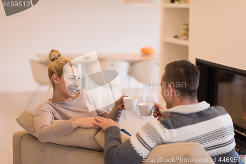 Image of Young couple  in front of fireplace