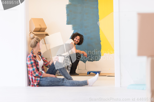 Image of young couple doing home renovations